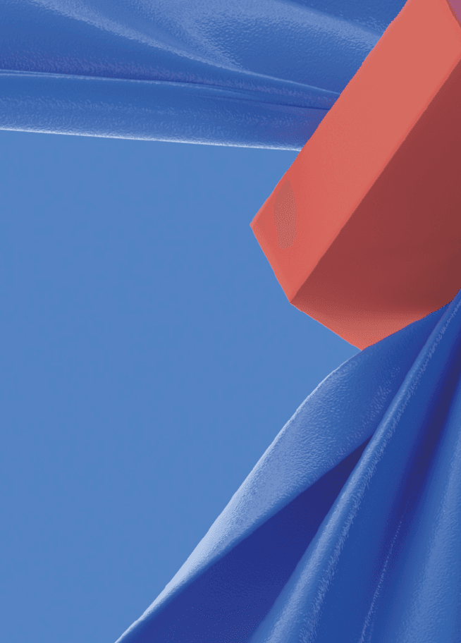 Orange-red block resting on folds of glossy blue fabric against a blue background