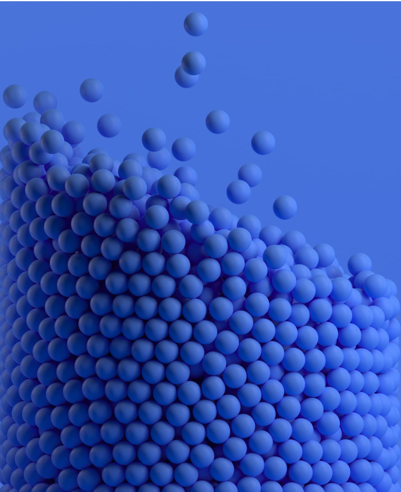 Dense mound of dark blue spheres, with several floating above against a slightly lighter blue background.