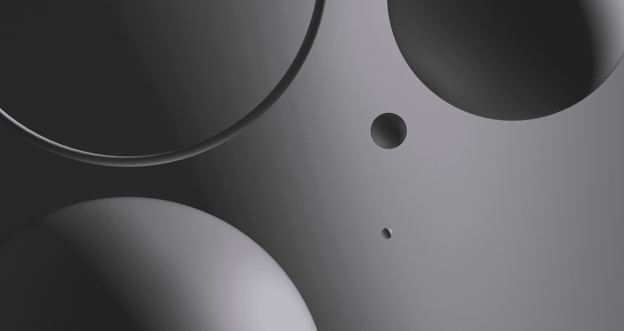 Abstract image of gray spheres and a ring, showing subtle gradients and depth.