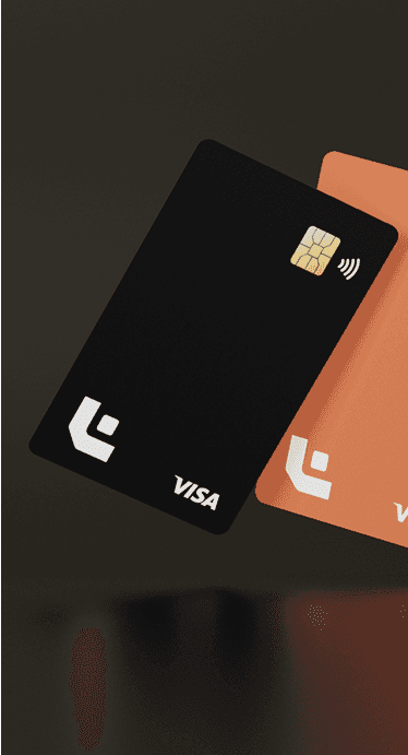Two modern credit cards, one black and one orange, with minimalistic design, visible chip, and contactless payment symbol.